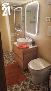a bathroom with a sink and a toilet and a mirror at Dimora Agata 21 in Ostuni +60 photos