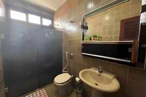 a bathroom with a sink and a toilet and a mirror at Studio Caju in Mossoró +24 photos