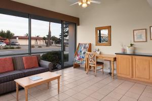 a living room with a couch and a table at Sand Dollar Inn in Seaside