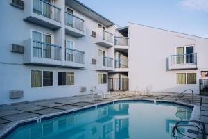 a swimming pool in front of a building at Sand Dollar Inn in Seaside