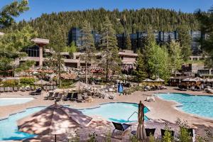 an outdoor pool with umbrellas and a resort at Olympic Valley Summer Stay: Everline Resort & Spa! in Olympic Valley