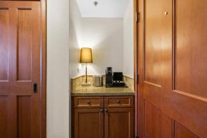 a room with a table with a lamp next to a door at Olympic Valley Summer Stay: Everline Resort & Spa! in Olympic Valley