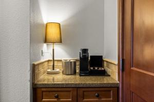 a lamp on a hotel room counter with a coffee maker at Olympic Valley Summer Stay: Everline Resort & Spa! in Olympic Valley