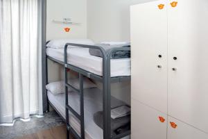 a bedroom with a bed and a desk at Meeting Point Hostels in Barcelona