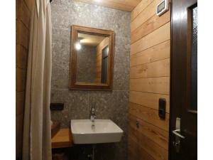 a bathroom with a sink and a mirror at Ferienhaus in Kollnburg mit Garten in Achslach +27 photos