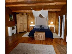 a bedroom with a bed with a canopy at Ferienhaus in Kollnburg mit Garten in Achslach