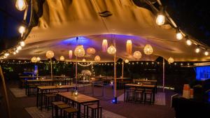 a restaurant with tables and lights in a tent at Holiday Inn Hotel Brussels Airport by IHG in Diegem