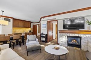 a living room with a fireplace and a kitchen at Resort Perks! Everline Corner Retreat w/ 3 Units in Olympic Valley