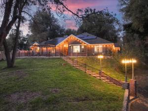 a house with lights on the yard at night at Splash Mountain in Oakhurst