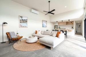 a living room with a couch and a table at Super-Styled Light-Filled Eco Home in Torquay