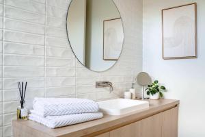a bathroom with a sink and a mirror at Super-Styled Light-Filled Eco Home in Torquay +24 photos