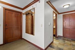 a hallway with two doors and a mirror at Valley-View Unit in Everline Resort: Premier Perks in Olympic Valley