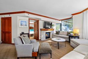a living room with a couch and a fireplace at High Sierra Summer Stay in Everline Resort & Spa! in Olympic Valley