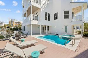 a patio with a swimming pool and a house at Dock N Dune by 30A Escapes in Seagrove Beach