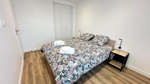 a bedroom with a bed in a white room at Les Jonquilles in Vernon