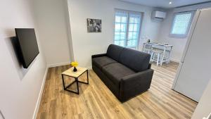 a living room with a couch and a table at Les Jonquilles in Vernon