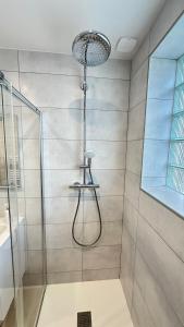 a shower with a glass door in a bathroom at Les Jonquilles in Vernon +18 photos
