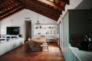 a kitchen and dining room with a table and chairs at Beautiful villa with private pool and mountain views in Jimena de la Frontera