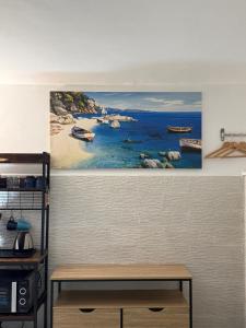 a painting of a beach with boats in the water at Capri Coral Home in Anacapri