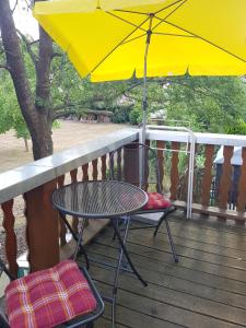 a table and chairs on a deck with an umbrella at Fewo 4 in Markkleeberg
