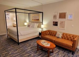 a hotel room with a bed and a couch at Bavarian Inn in Shepherdstown