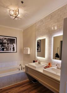 a bathroom with two sinks and a tub at Bavarian Inn in Shepherdstown