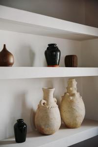 three vases are sitting on a shelf at Beautiful villa with private pool and mountain views in Jimena de la Frontera