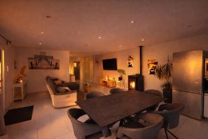 a large living room with a table and chairs at Maison avec piscine in Golbey