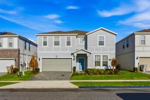 a large white house with a garage at Windsor Resort Private Pool & Theater Game Room in Davenport