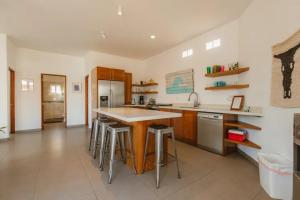 a kitchen with a table and some bar stools at Baja Beach Pad at Cerritos in El Pescadero