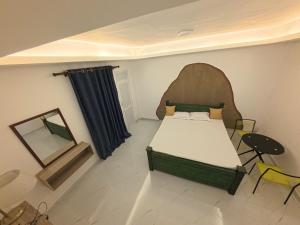 a bedroom with a bed and a table and chairs at SeekRide Bolgoda in Bandaragama