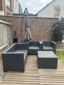 a patio with two benches and an umbrella at Always luxury for a luxurious life in Grimbergen +2 photos