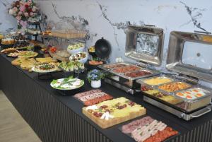 a buffet with many different types of food on a table at Hotel Tommy in Budva