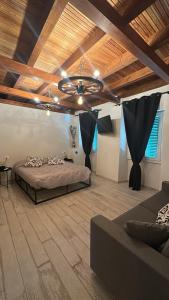 a bedroom with a bed and a wooden ceiling at Le Cantine della Nelli in Genoa