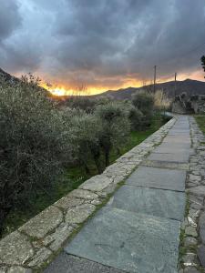 a stone path with a sunset in the background at Le Cantine della Nelli in Genoa
