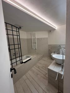 a bathroom with a tub and a sink and a toilet at Le Cantine della Nelli in Genoa +11 photos