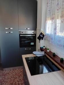a kitchen with a stove and a refrigerator at Alloggio Veronica in Voghera
