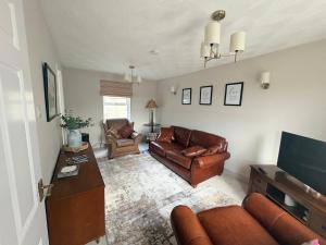 a living room with a couch and a table at Bide A While at the Port in Portrush