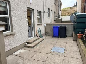 an alley with a door and a washing machine at Bide A While at the Port in Portrush