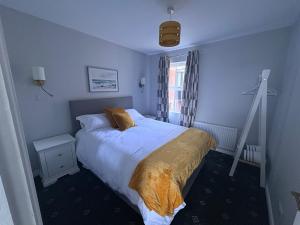 a bedroom with a bed and a ladder in it at Bide A While at the Port in Portrush