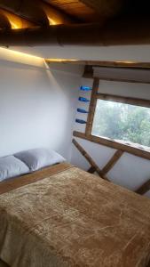 a bedroom with a bed and a window at Torre de Guadua in Medellín +17 photos