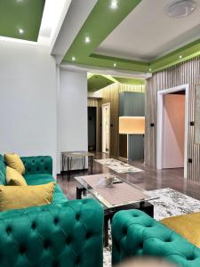 a living room with green furniture and a table at Cataleya III in Sarajevo