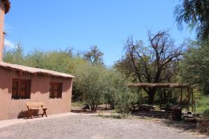 a house with a picnic table in front of it at Casa Garces in San Pedro de Atacama