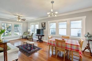a dining room with a table and chairs and a living room at The Little Bungalow in Houston