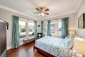 a bedroom with a bed and a ceiling fan at The Little Bungalow in Houston