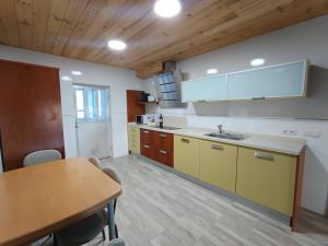 a kitchen with a table and a sink in a room at Casa Patio Zamora in Zamora +6 photos