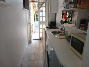 a kitchen with a sink and a counter top at Chez Myky in Sainte-Marie