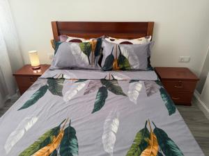 a bed with a bunch of pillows on it at Ocean Palm Apartments II - Edifício Paradis- Cidadela in Praia
