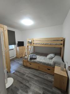 a bedroom with two bunk beds and a flat screen tv at Casa Patio Zamora in Zamora