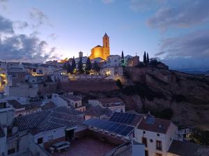 a city with a church on top of a mountain at Casa Patio de la Antigua in Iznájar